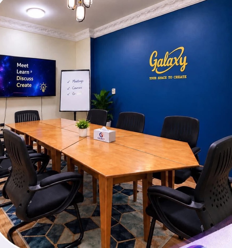 Saturn meeting room with a long table, a screen and a flip chart